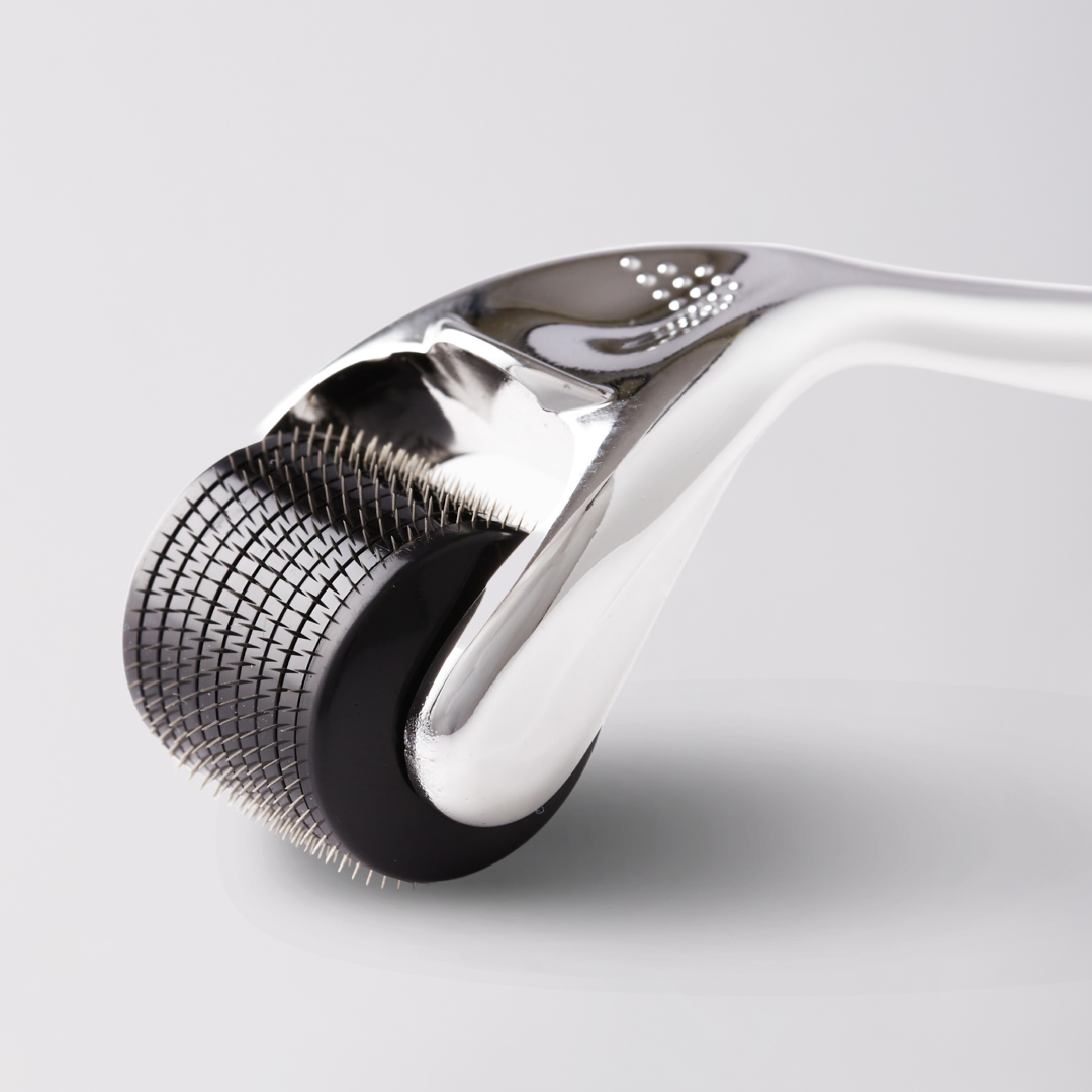Close-up of a derma roller with metallic head on a light gray background